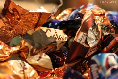 Crew securing commercial bins for safe collection by an insured waste removal company